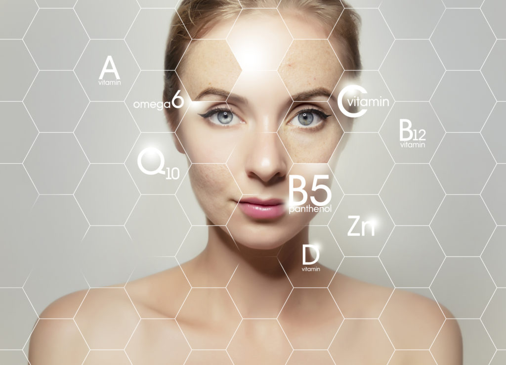 woman face portrait with graphic icons of vitamins and minerals for skin treatment