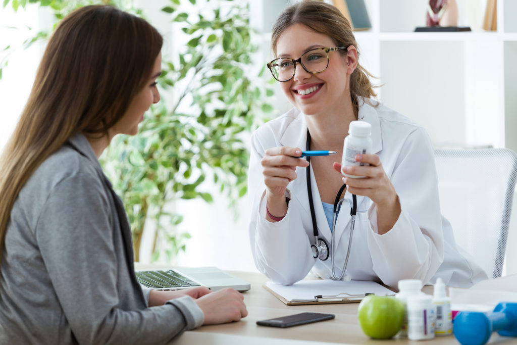 Female dietician prescribing nutritional supplement for patient in the consultation.