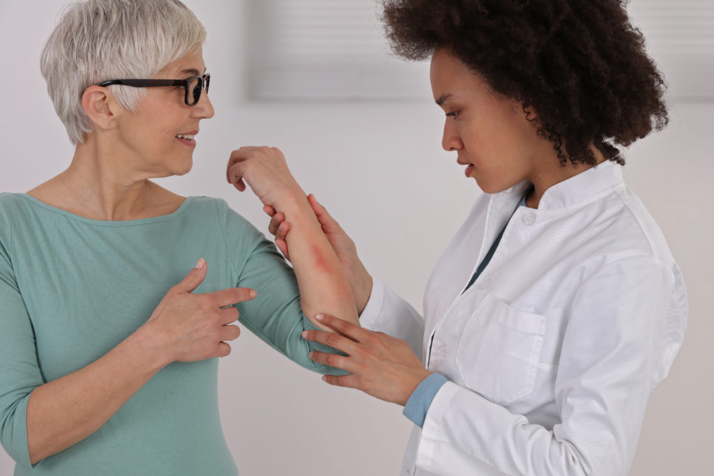 Woman being treated by a dermatologist.